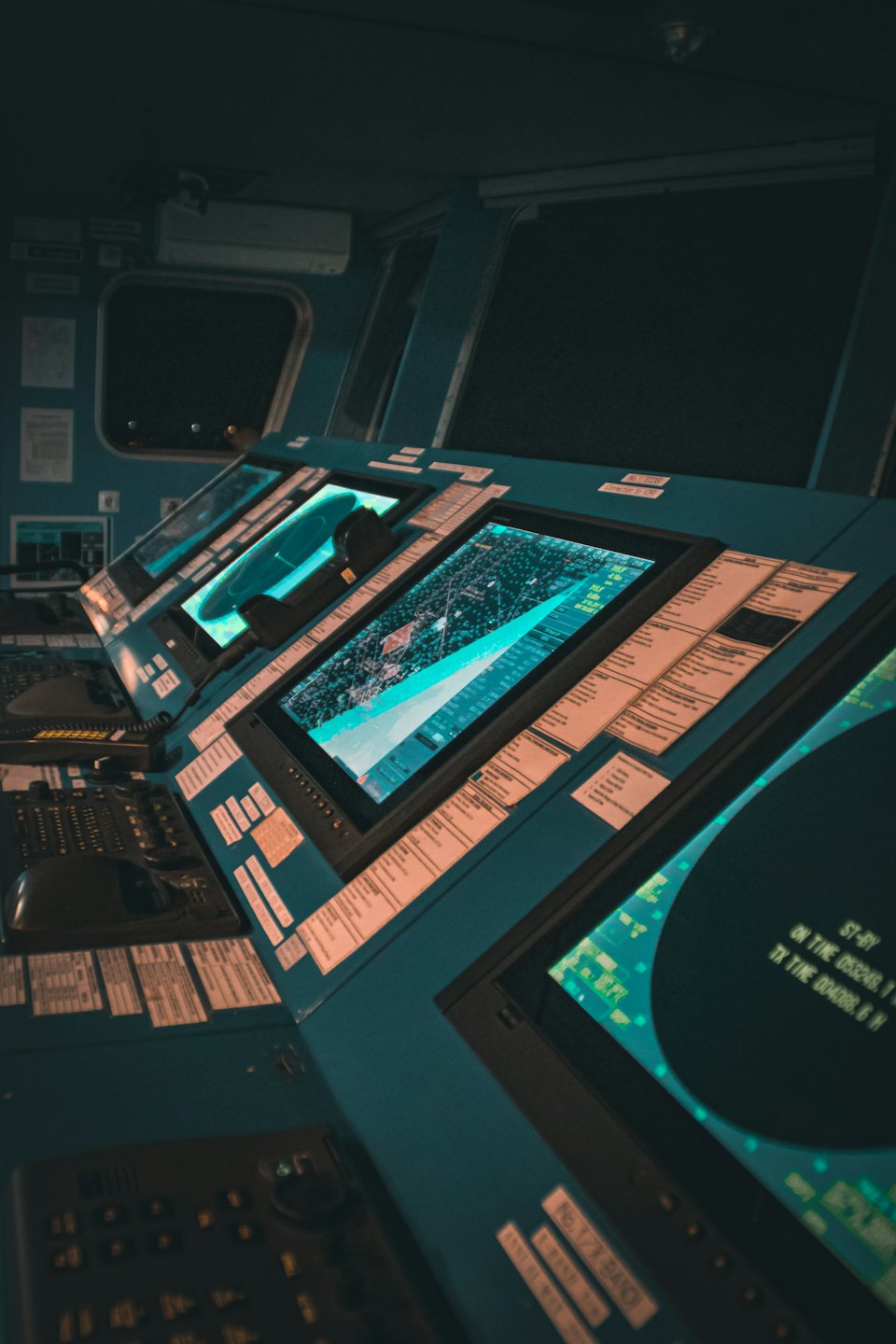 Ship's bridge displays showing navigation and radar data.
